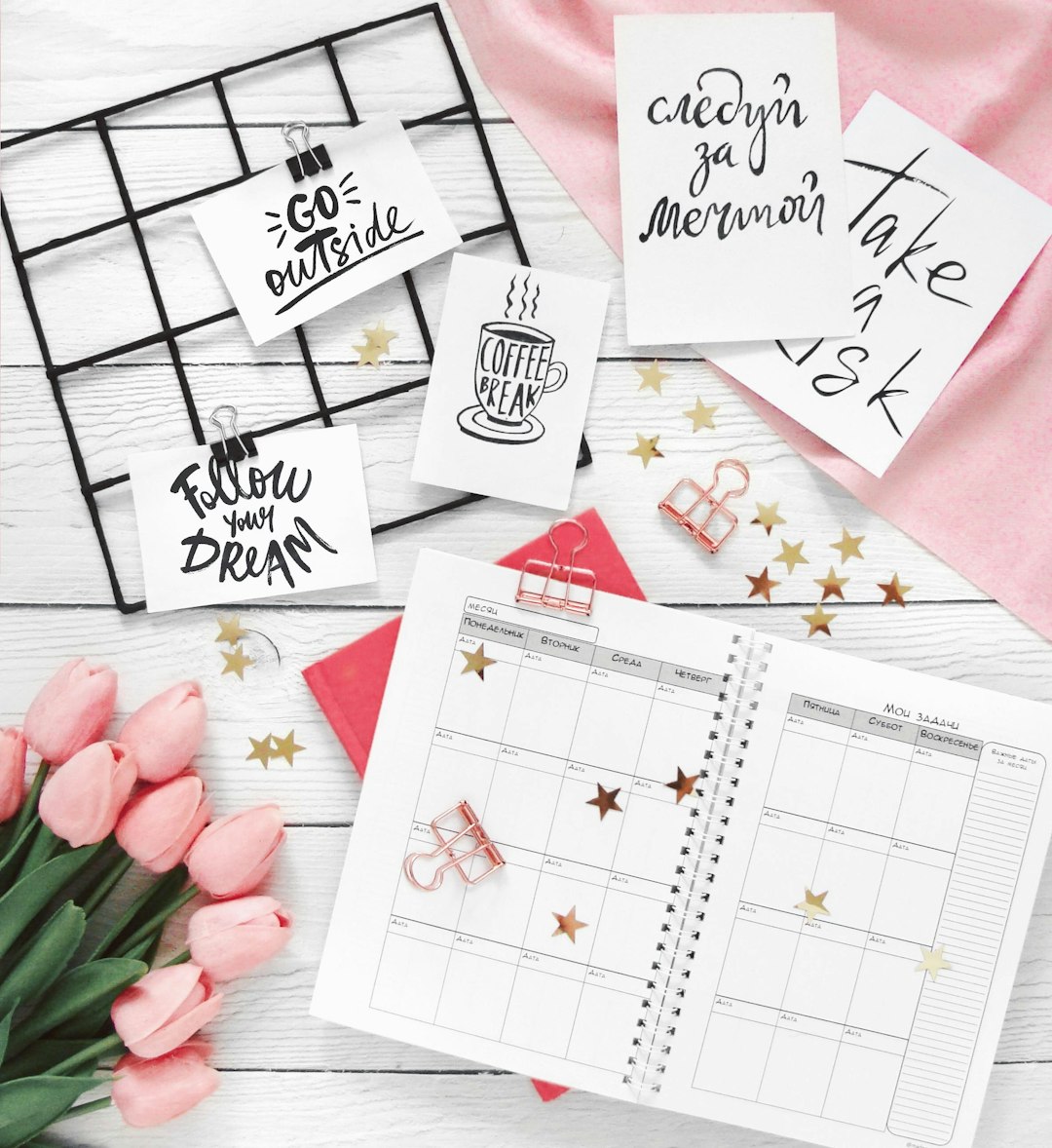 wrote my book — Tulips, planner, and motivational notes on desk