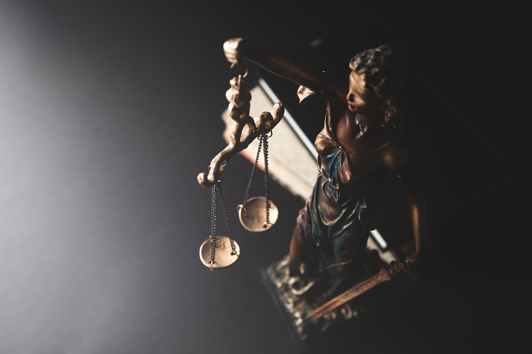 second chance act — Statue of justice with scales on dark background