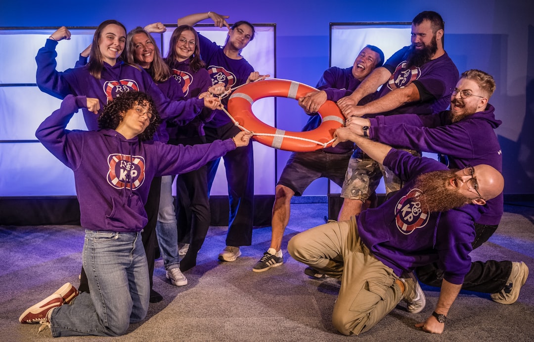 federal self-surrender — Group of people in purple hoodies holding a life preserver