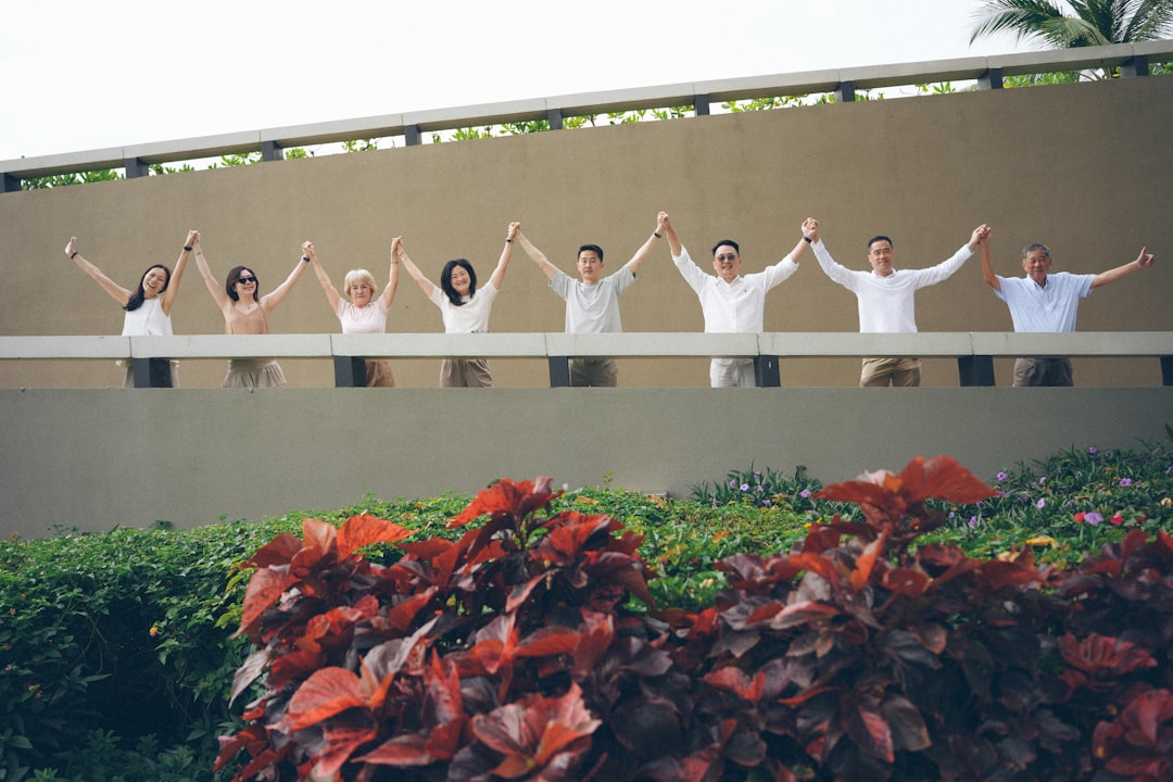 mental health after incarceration — Group of people holding hands with arms raised