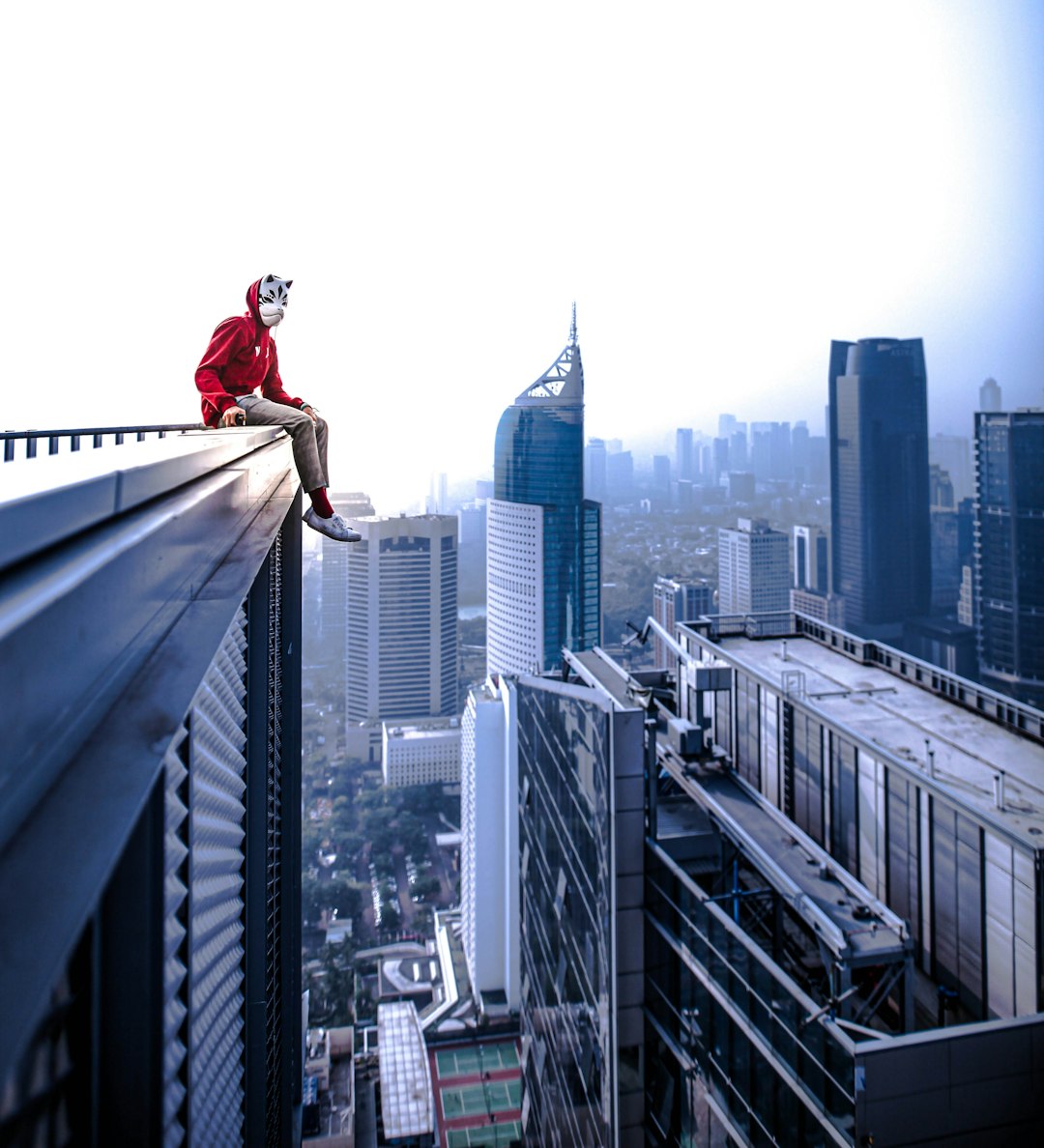 federal prison reentry — man sitting on curtain wall building