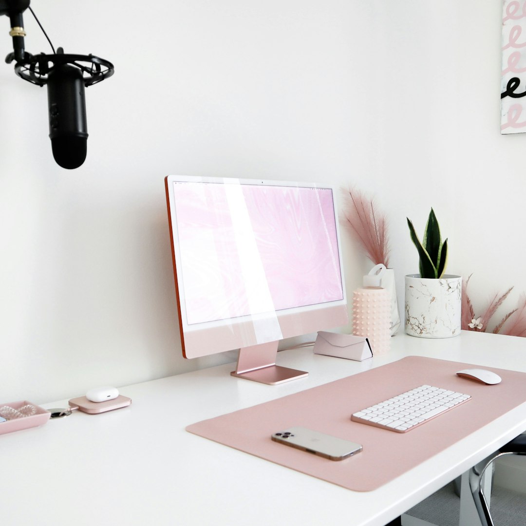 home confinement rules — a white desk with a pink computer on it